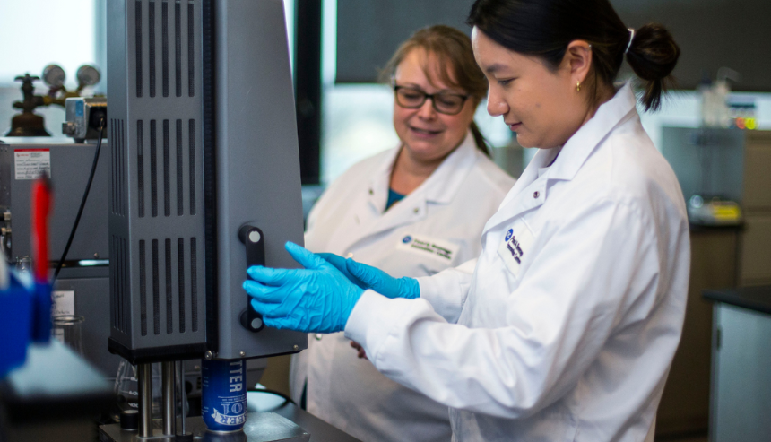 Two researchers inspecting beer at the Food and Beverage Innovation Centre.