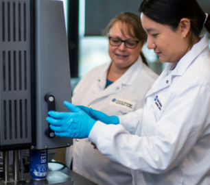 Two researchers inspecting beer at the Food and Beverage Innovation Centre.