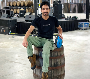 Gaurab Devkota sitting on a wine barrel