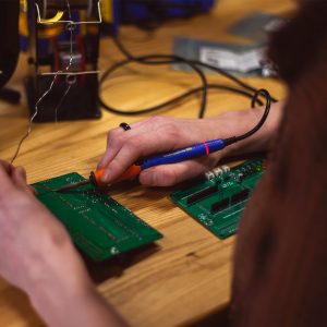 Person working on a circuit board